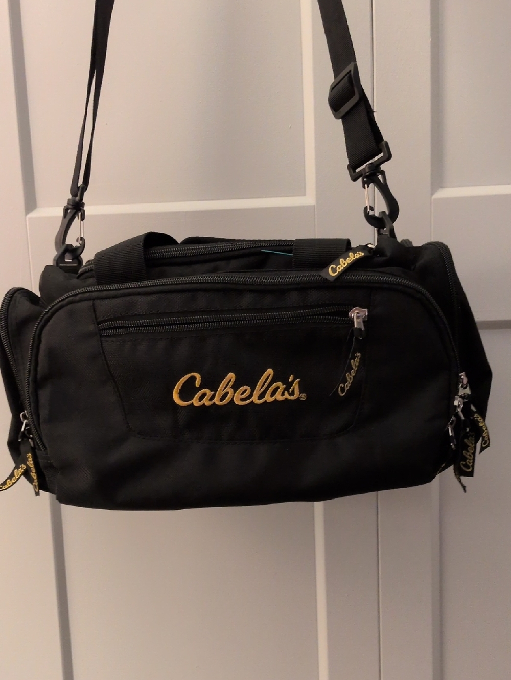 Cabela's Black Duffel Bag with Gold Logo and Adjustable Strap